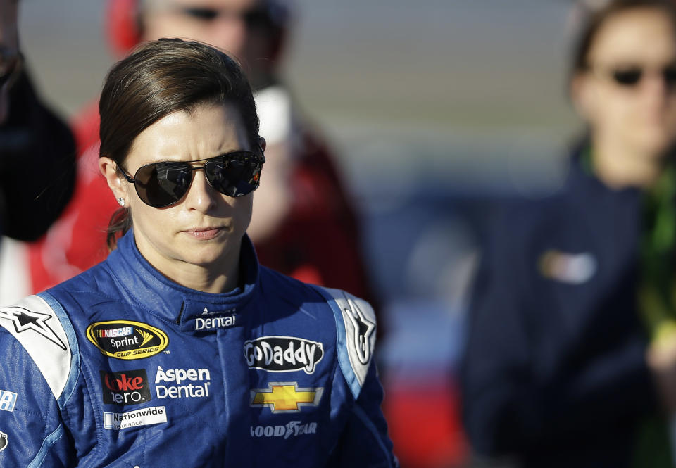 Danica Patrick walks down pit row following qualifying for Sunday's NASCAR Sprint Cup Series auto race, Friday, March 7, 2014, in Las Vegas. (AP Photo/Isaac Brekken)