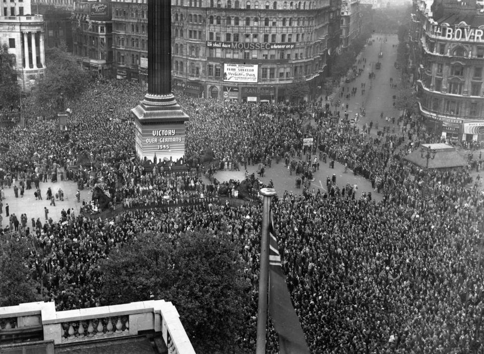 VE day, held to commemorate the official end of World War II in Europe, is celebrated by crowds at Trafalgar Square in London, 8th May 1945. (Photo by Fred Morley/Fox Photos/Hulton Archive/Getty Images)