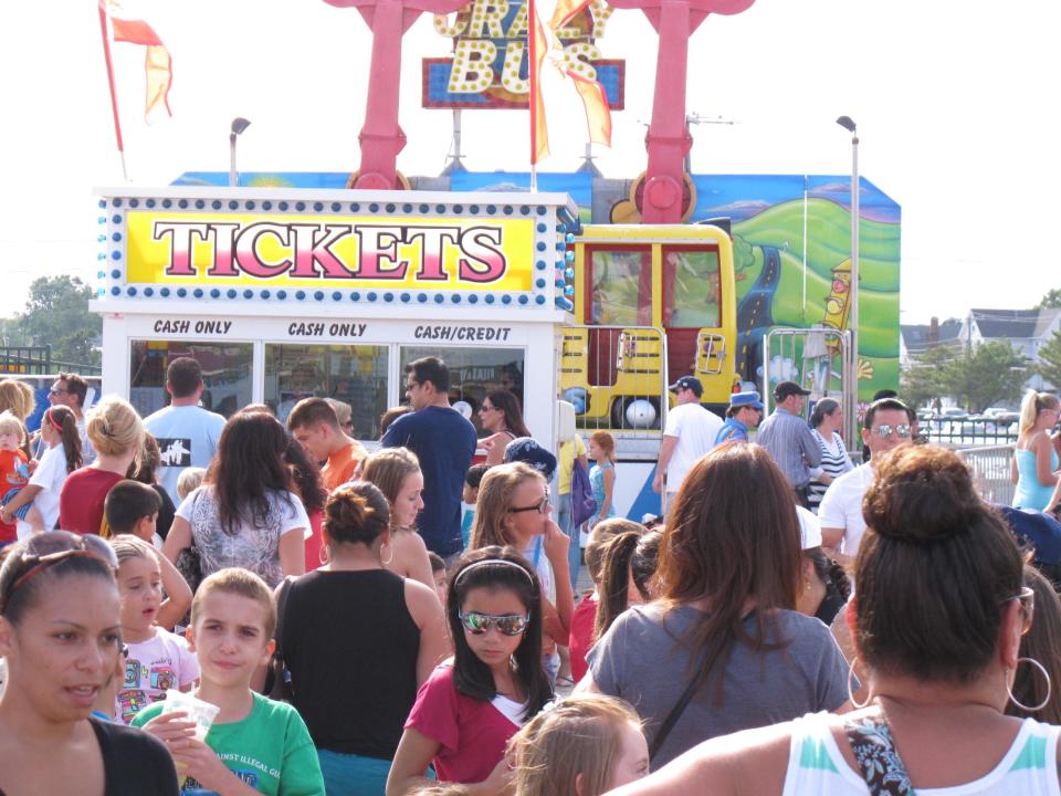 Customers wait in line for tickets for boardwalk rides in Point Pleasant Beach, N.J. on Aug. 16, 2013. A new Monmouth University/Asbury Park Press poll finds nearly 40 percent of New Jerseyans spent less time at the shore this summer, many fearing that businesses had not reopened after Superstorm Sandy last October. (AP Photo/Wayne Parry)