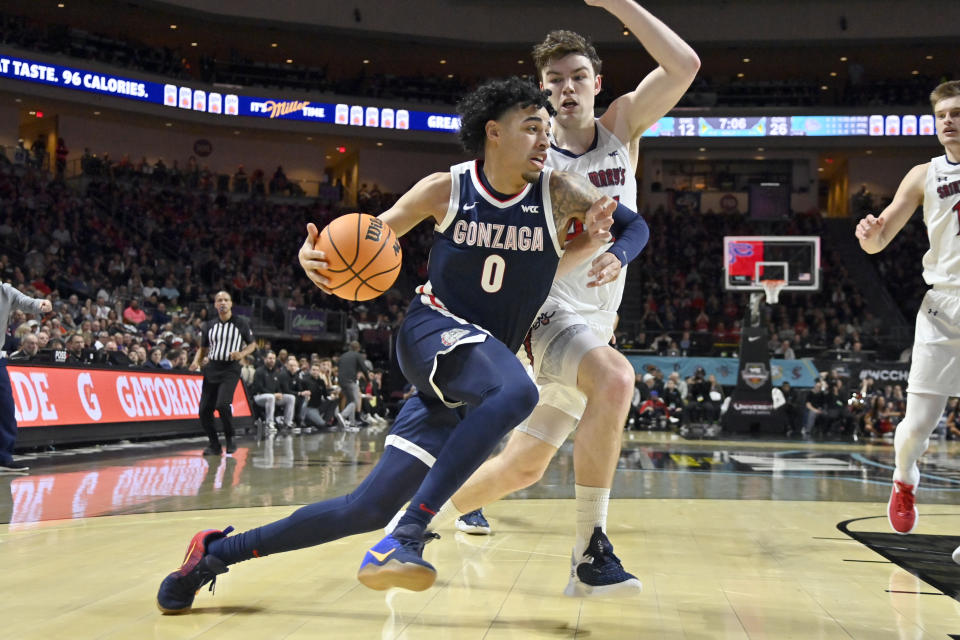 Gonzaga guard Julian Strawther (0) drives the ball against St. Mary's guard Alex Ducas during the first half an NCAA college basketball game in the finals of the West Coast Conference men's tournament Tuesday, March 7, 2023, in Las Vegas. (AP Photo/David Becker)