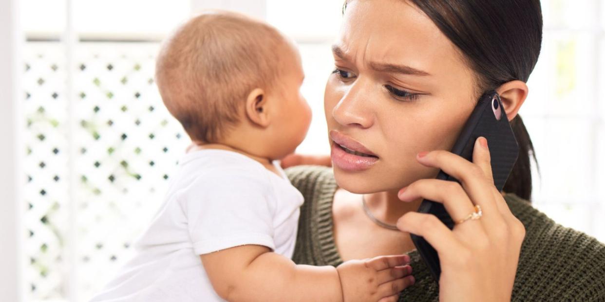 Woman on phone holding baby