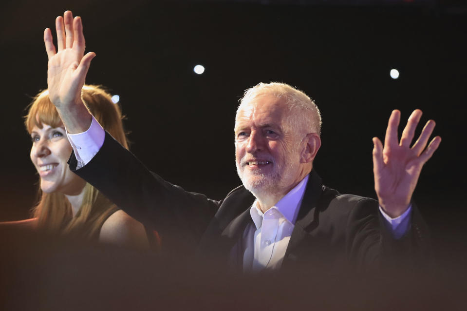 Labour Party leader Jeremy Corbyn and shadow education secretary Angela Rayner acknowledge supporters at the Grand Central Hall in Liverpool, England, on Saturday Oct. 19, 2019, after the Letwin amendment, which seeks to avoid a no-deal Brexit on October 31, was accepted by the House, following Prime Minister Boris Johnson's statement in the House of Commons over his new Brexit deal. (Danny Lawson/PA via AP)