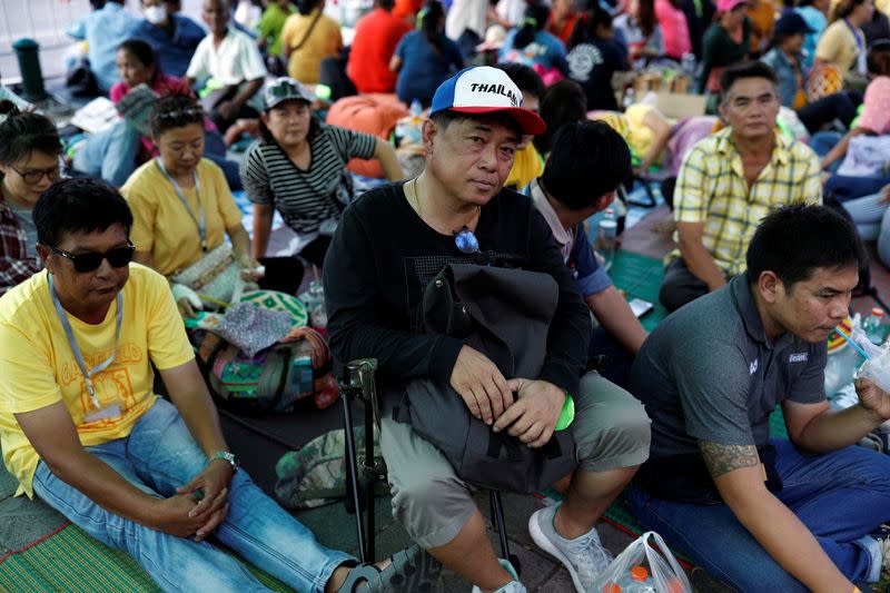 Family members in the fishing industry sit at a protest outside the Agriculture Ministry in Bangkok