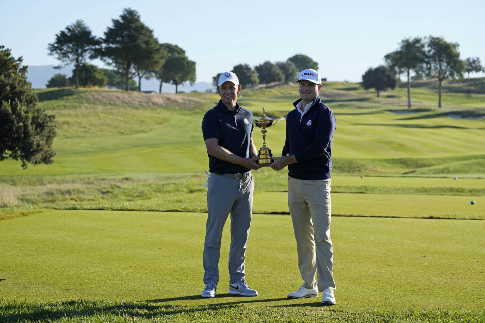 European Captain Luke Donald, left, and United States Captain Zach Johnson pose with the Ryder Cup trophy before an exhibition match on the occasion of The Year to Go event at the Marco Simone course that will host the 2023 Ryder Cup, in Guidonia Montecelio, near Rome, Italy, Monday, Oct. 3, 2022. (AP Photo/Alessandra Tarantino)