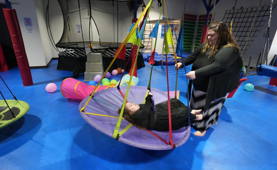 Manager Ashley McCarthy plays with her daughter, Avery, 7, at the gym on Nov. 23.