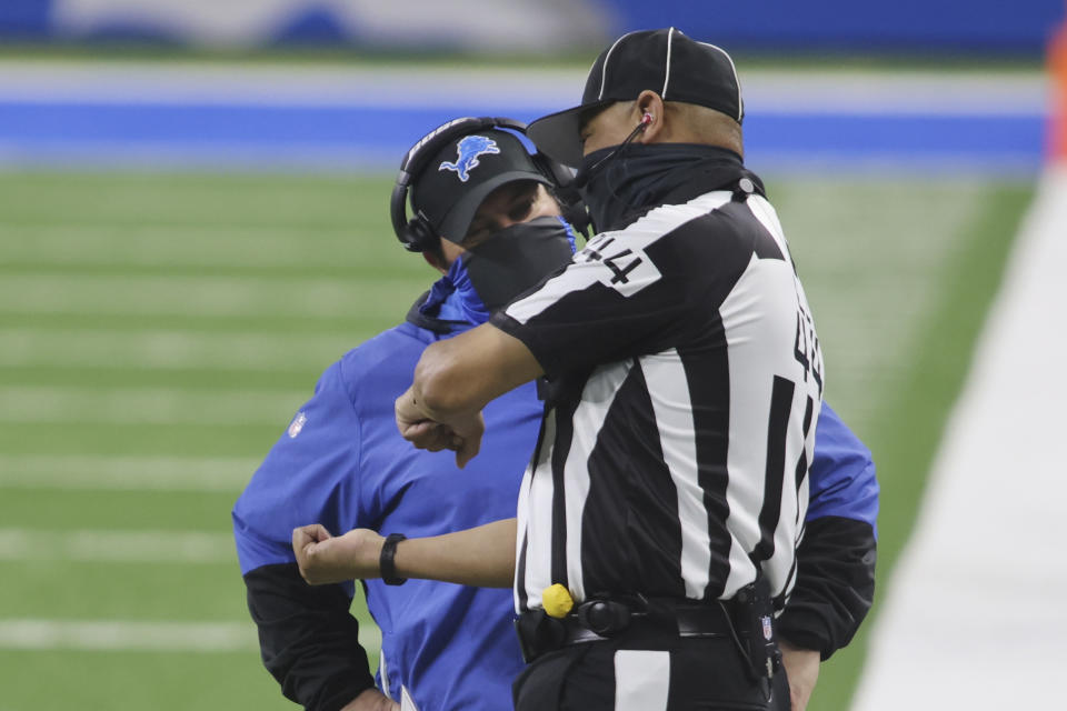 Detroit Lions head coach Matt Patricia talks with umpire Jeff Rice (44) during the first half of an NFL football game against the Indianapolis Colts, Sunday, Nov. 1, 2020, in Detroit. (AP Photo/Tony Ding)