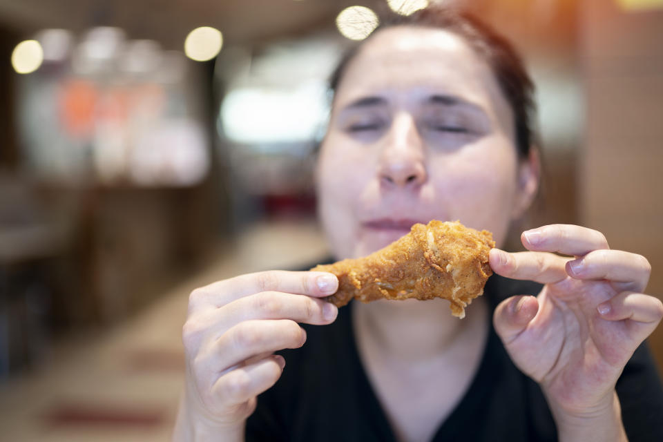 Young woman with fried chicken