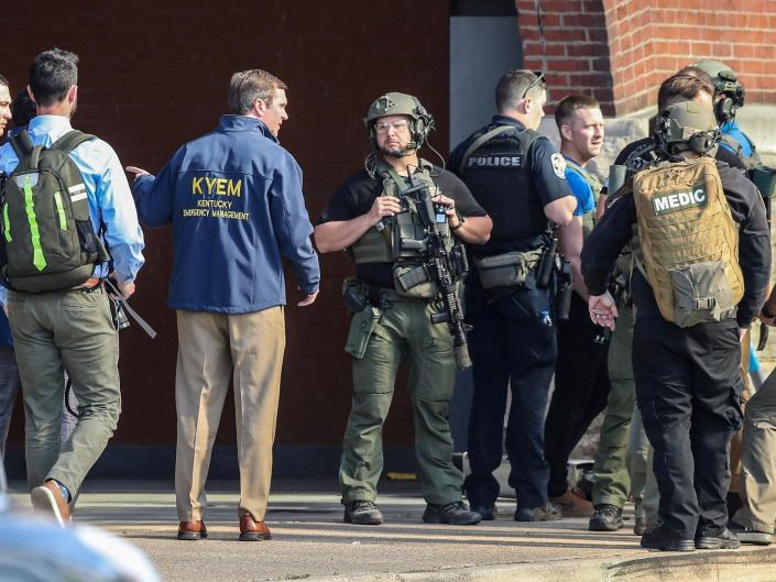 Kentucky Governor Andy Beshear speaks with police deploying at the scene of a mass shooting near Slugger Field baseball stadium in downtown Louisville, Kentucky