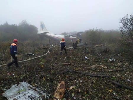 Members of emergency services work at the site of the Antonov-12 cargo airplane emergency landing in Lviv region