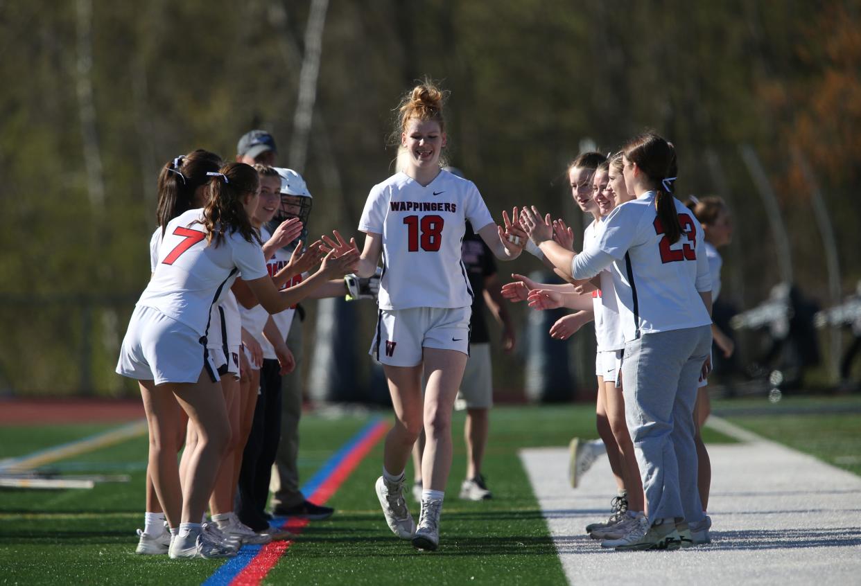 The Wappinger girls lacrosse team cheer on Mackenzie Velsmid before their game versus Tappan Zee on April 25, 2024.