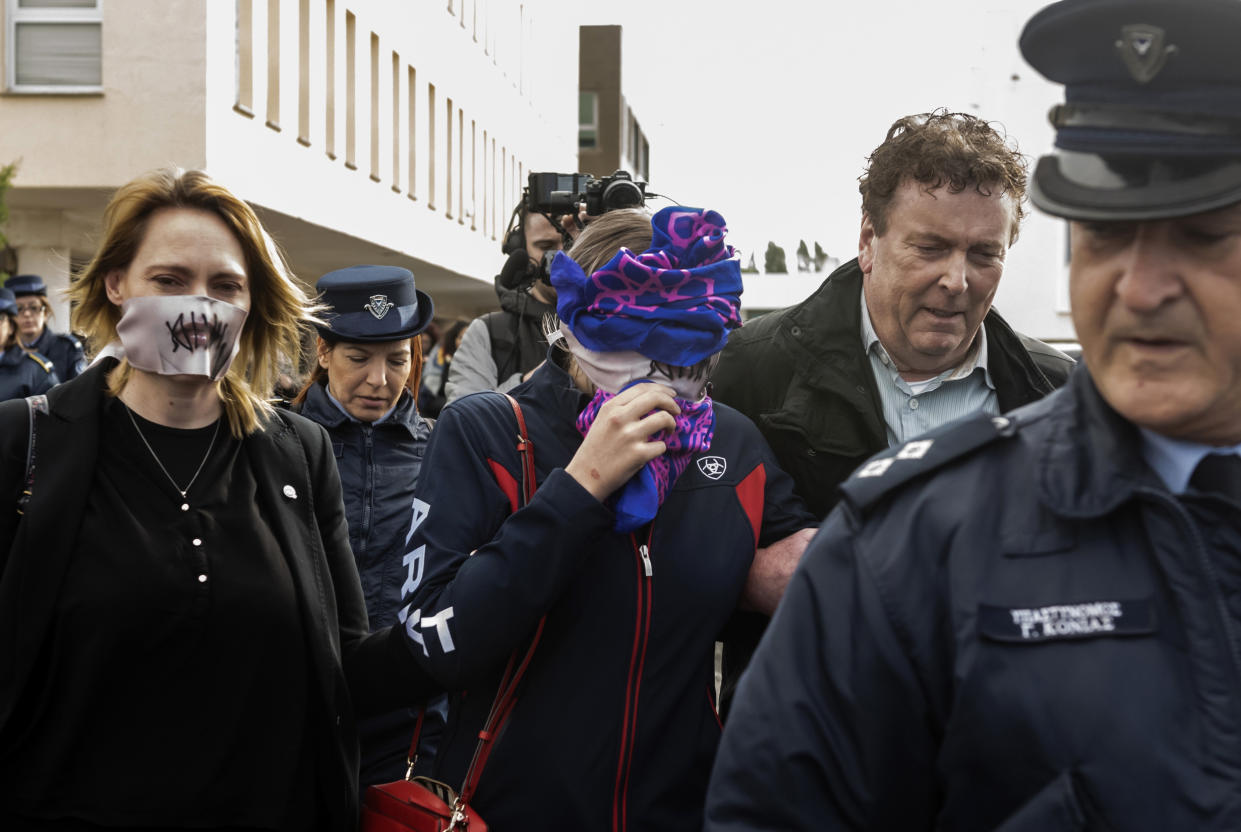 A British teenager (C) accused of falsely claiming she was raped by Israeli tourists, covers her face as she leaves after the verdict at the Famagusta District Court in Paralimni in eastern Cyprus, on December 30, 2019. - The Briton who had alleged 12 Israeli tourists gang raped her on July 17, at a hotel in the eastern resort of Ayia Napa, has been found guilty of lying by a Cypriot court, her sentencing adjourned until January 7. (Photo by Iakovos Hatzistavrou / AFP) (Photo by IAKOVOS HATZISTAVROU/AFP via Getty Images)