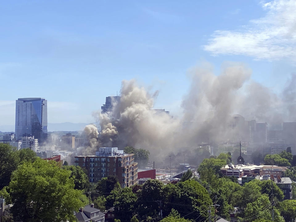 Smoke rises from a major apartment fire in downtown Portland, Ore., Tuesday, May 16, 2023. Firefighters rescued people and at least one dog from a dramatic, three-alarm apartment fire in downtown Portland on Tuesday before they were ordered to fall back. (Mims Copeland/The Oregonian via AP)