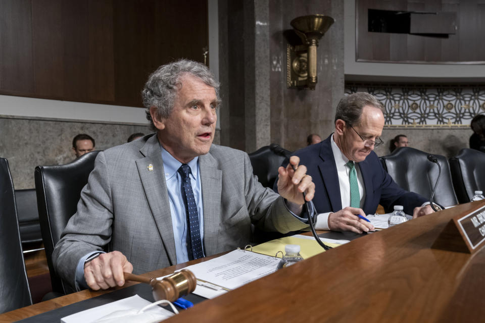 Sen. Sherrod Brown, D-Ohio, chairman of the Senate Banking Committee, and Sen. Pat Toomey, R-Pa., right, the ranking member, lead a hearing on cryptocurrency and the collapse of the FTX crypto exhange and its founder Sam Bankman-Fried, at the Capitol in Washington, Wednesday, Dec. 14, 2022. (AP Photo/J. Scott Applewhite)
