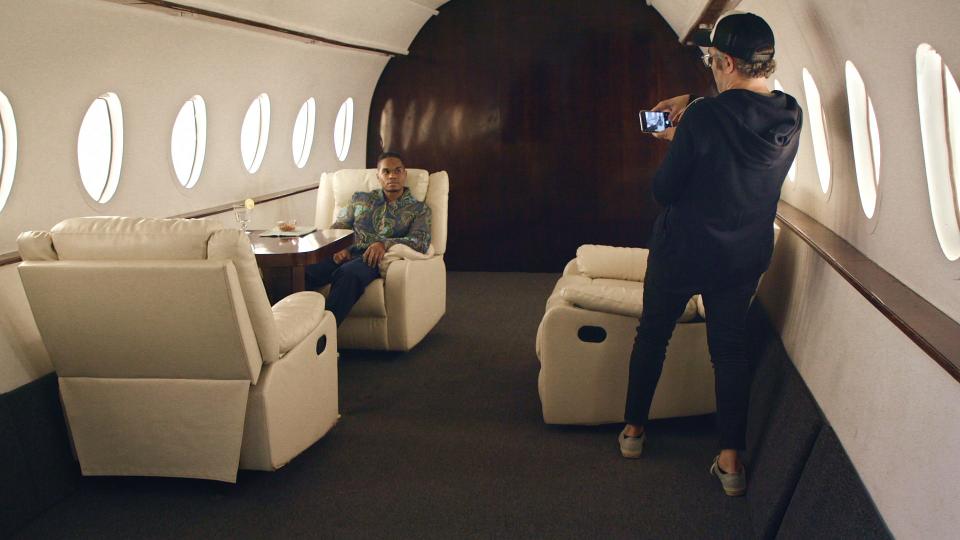 Creating a false online persona, Nick Bilton photographs Chris Bailey in a space designed to look like a private jet.