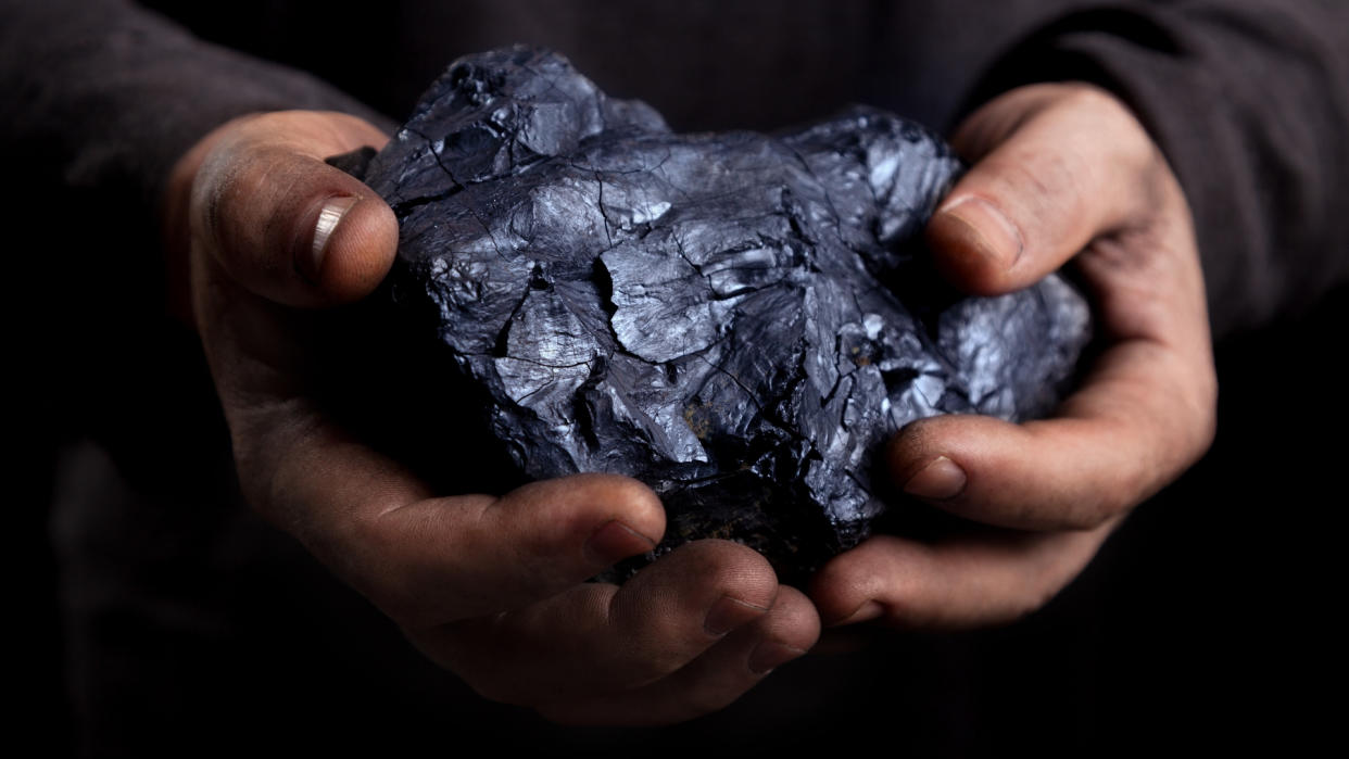 Hand with coal. 