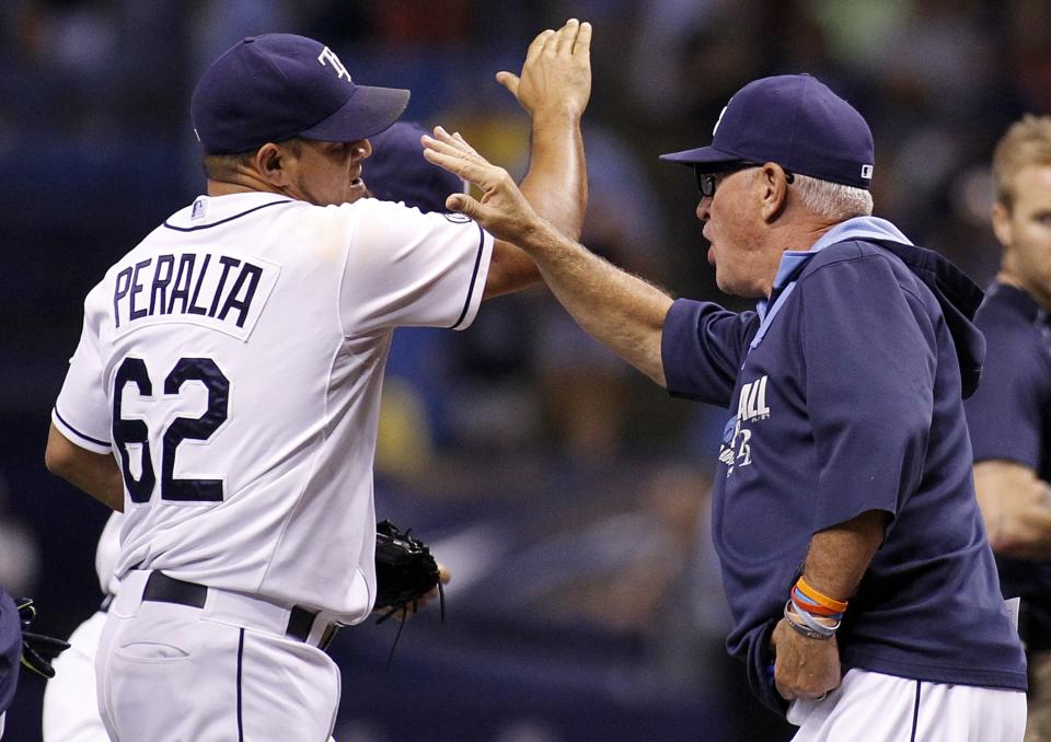 Manger Joe Maddon celebrates with pitcher Joel Peralta following the Rays 5-0 win over the Yankees. (Getty) 