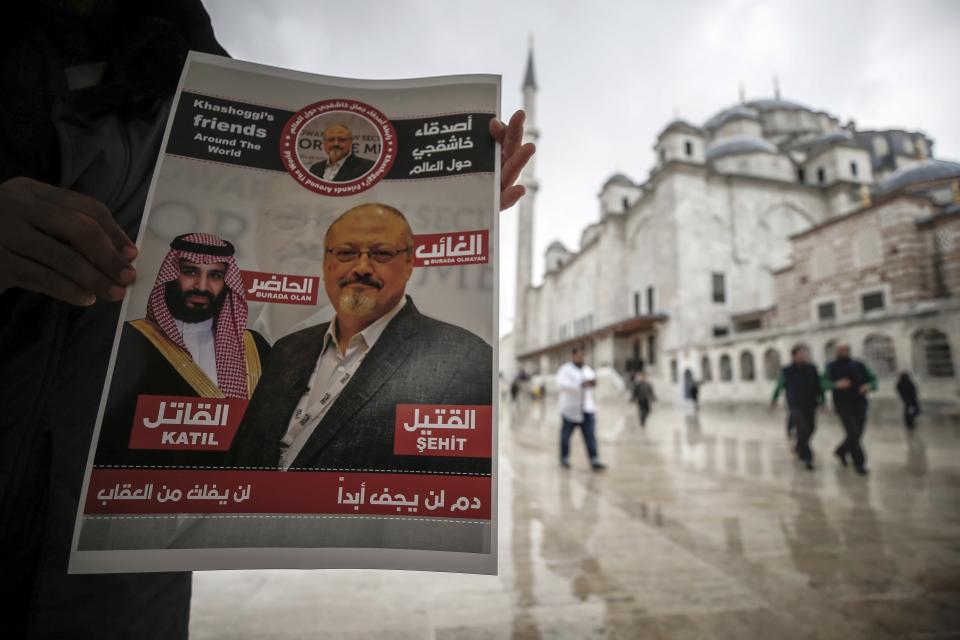 FILE - A man holds a poster showing images of Saudi Crown Prince Muhammed bin Salman and of journalist writer Jamal Khashoggi, describing the prince as "assassin" and Khashoggi as "martyr" during funeral prayers in absentia for Khashoggi who was killed in the Saudi Arabia consulate, in Istanbul, on Nov. 16, 2018. A Dubai-based broadcaster cut substantial portions of a recent episode of the satiric news program "Last Week Tonight with John Oliver" over references to Saudi Arabia's crown prince being implicated in the 2018 killing of Washington Post columnist Jamal Khashoggi. (AP Photo/Emrah Gurel, File)