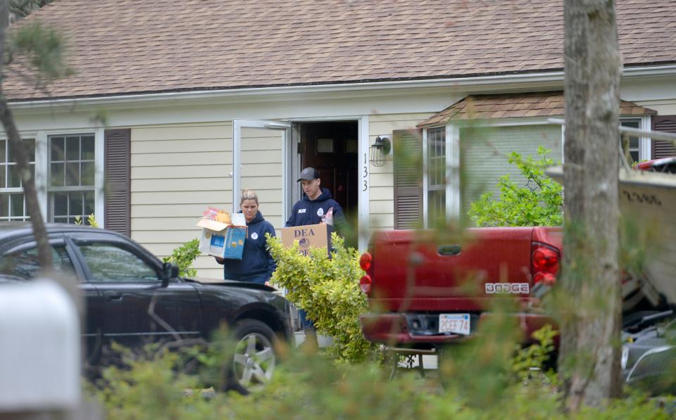 Boxes of evidence are taken out of the house at 133 Azalea Drive on May 19. Merrily Cassidy/Cape Cod Times