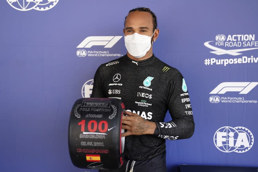 Mercedes driver Lewis Hamilton of Britain poses after he clocked the fastest time in the qualifying for the Spanish Formula One Grand Prix at the Barcelona Catalunya racetrack in Montmelo, just outside Barcelona, Spain, Saturday, May 8, 2021. The Spanish Grand Prix will be held on Sunday. (AP Photo/Emilio Morenatti, Pool)