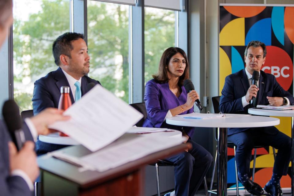Mississauga mayoral candidates Dipika Damerla, centre, Stephen Dasko, right, and Alvin Tedjo, left, take part in a live debate hosted by the CBC’s David Common, at the Living Arts Centre, on May 30, 2024.