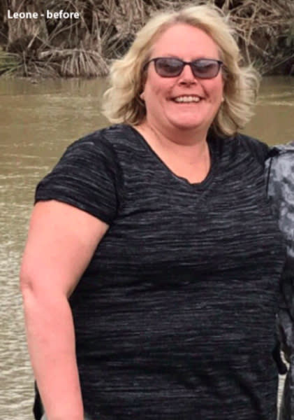 A blonde woman wearing a black t-shirt and sunglasses