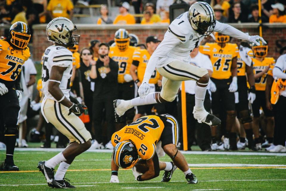 Vanderbilt's Elijah McAllister (1) hurdles Missouri's Cody Schrader (20) at the end of the play during the Tigers' 17-14 win over the Commodores on Oct. 22, 2022.