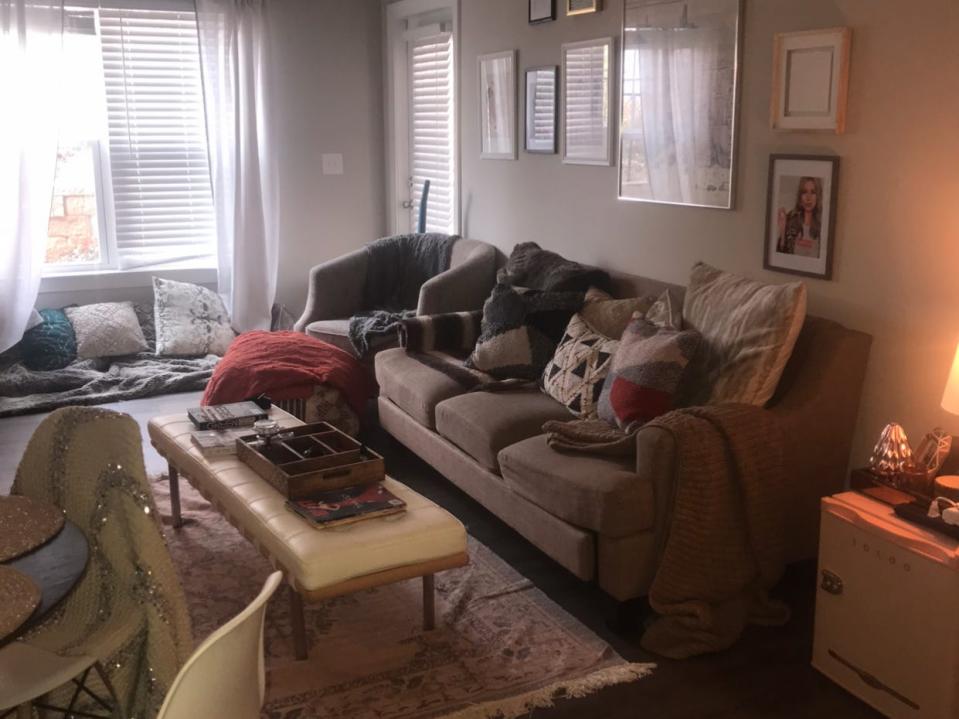 authors apartment with couch and coffee table, art on the walls