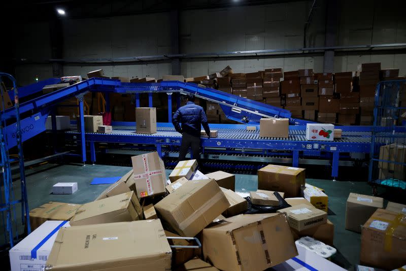 A worker monitors parcels on a conveyor belt at a Hanjin Transportation distribution centre in Gwangju