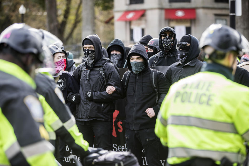 <p>Counter-protesters link arms while facing a wall of bike police outside of an Alt-Right organized free speech event on the Boston Common on Nov. 18, 2017, in Boston, Mass. (Photo: Scott Eisen/Getty Images) </p>