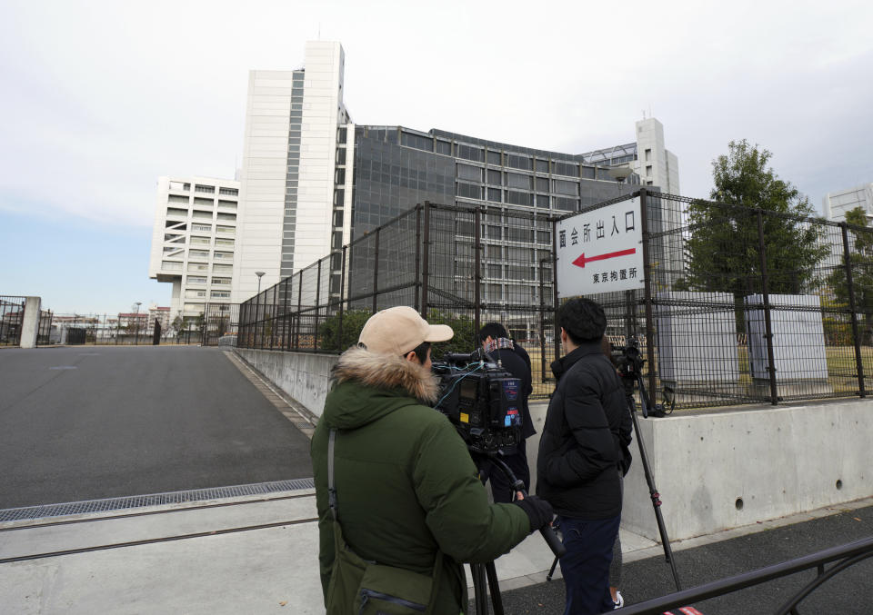 Journalists stand outside Tokyo Detention Center where former Nissan chairman Carlos Ghosn is being detained, Monday, Dec. 10, 2018, in Tokyo. Tokyo prosecutors say Ghosn, who was arrested on Nov. 19, is suspected of underreporting income by 5 billion yen ($44 million) over five years. Japanese media are reporting that the government Securities and Exchange Surveillance Commission is accusing Nissan as a company, along with Ghosn and another executive, of underreporting income. (AP Photo/Eugene Hoshiko)