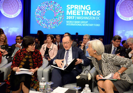 World Bank Group President Jim Yong Kim (C), IMF Managing Director Christine Lagarde (R) and Indonesia's Finance Minister Sri Mulyani Indrawati are seated prior to the start of the Development Committee Plenary, as part of the IMF and World Bank's 2017 Annual Spring Meetings, in Washington, U.S., April 22, 2017. REUTERS/Mike Theiler