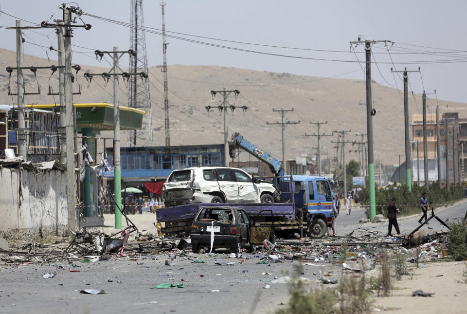 Damaged cars are seen at the site of a suicide attack in Kabul, Afghanistan, Thursday, July 25, 2019. Three bombings struck the Afghan capital on Thursday, killing at least eight people, including five women and one child, officials said Thursday. (AP Photo/Rahmat Gul)