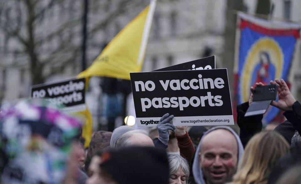 Anti -COVID-19 vaccination protesters demonstrate on Whitehall near Downing Street, in London, Saturday, Dec. 18, 2021. Hundreds of people protested in London Saturaday, blocking traffic as they marched with signs bearing slogans such as “Vaccine passports kill our freedoms” and “Don’t comply.” (Ian West/PA via AP)