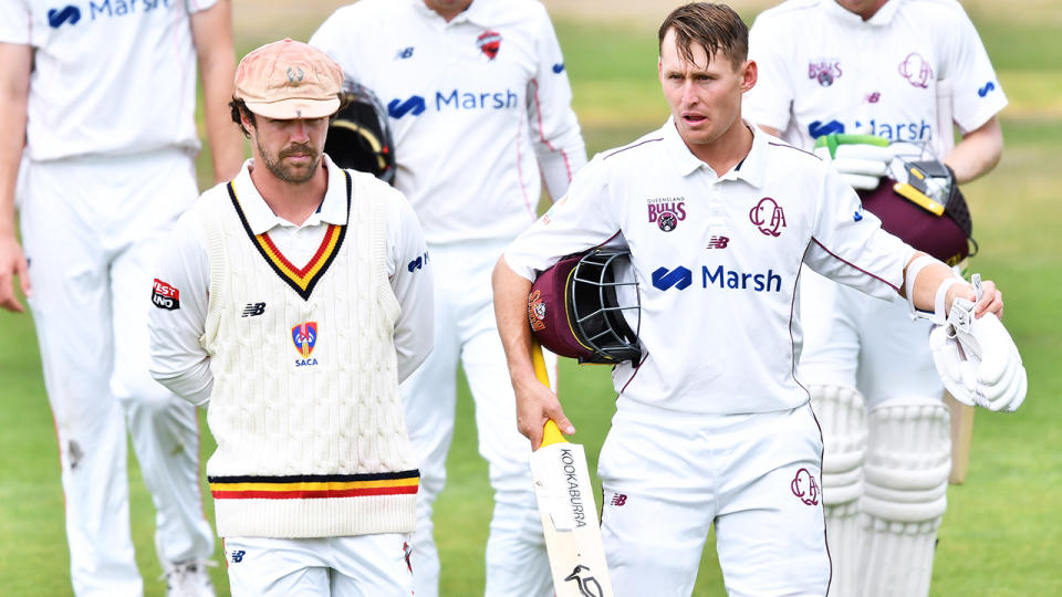 Travis Head and Marnus Labuschagne, pictured here walking from the field after play was abandoned.