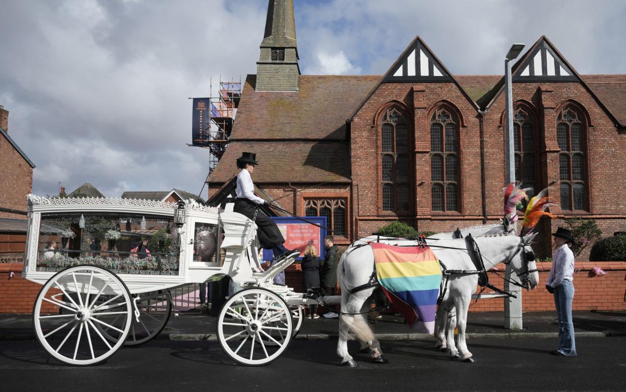 Elsie Dot Stancombe's coffin was carried to St John's church in a white horse-drawn carriage draped in rainbow fabric