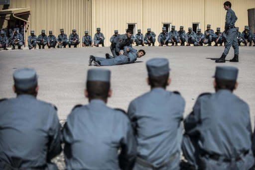 Afghani policemen attend a training session n Wardak province. A suicide car bomber has killed three people and wounded dozens near the NATO-run training base, in an attack claimed by the Taliban as revenge for the execution of its militants