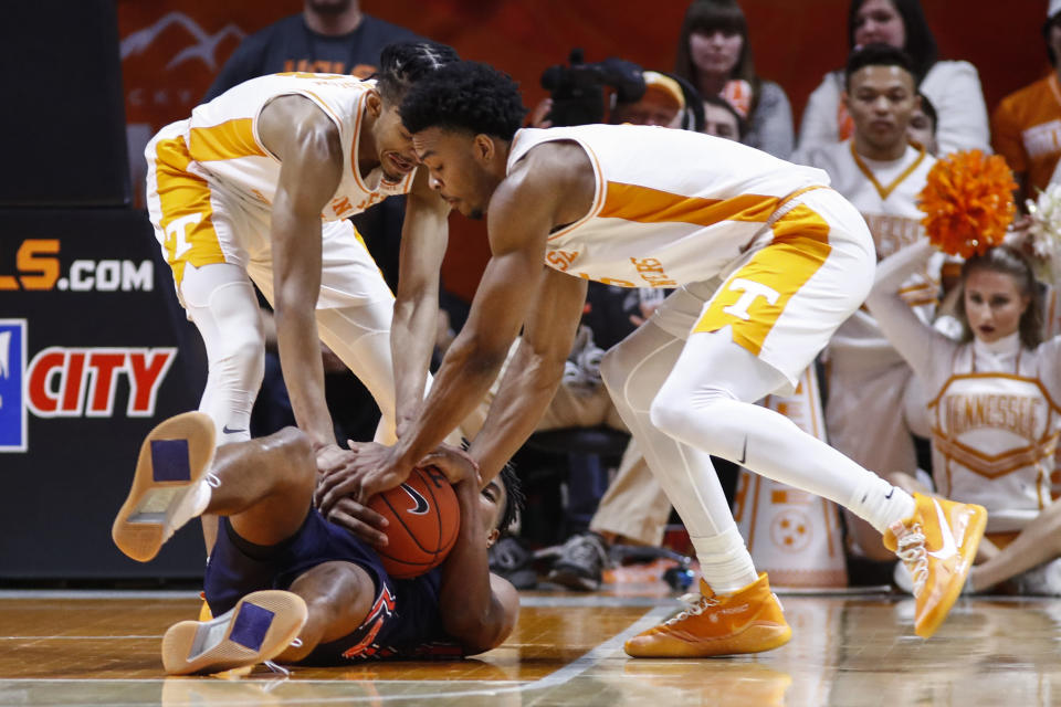 Auburn guard Allen Flanigan (22) scrambles for the ball as Tennessee guard Josiah-Jordan James (5) and guard Jalen Johnson (13) try to take it away during an NCAA college basketball game Saturday, March 7, 2020, in Knoxville, Tenn. (AP Photo/Wade Payne)