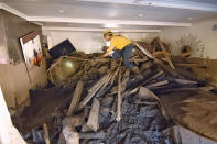 <p>Santa Barbara County Firefighter Vince Agapito searches through a Montecito, Calif., home on Jan. 13 that was destroyed by deadly mudflow and debris early Tuesday morning following heavy rainfall. (Photo: Mike Eliason/Santa Barbara County Fire Department via AP) </p>