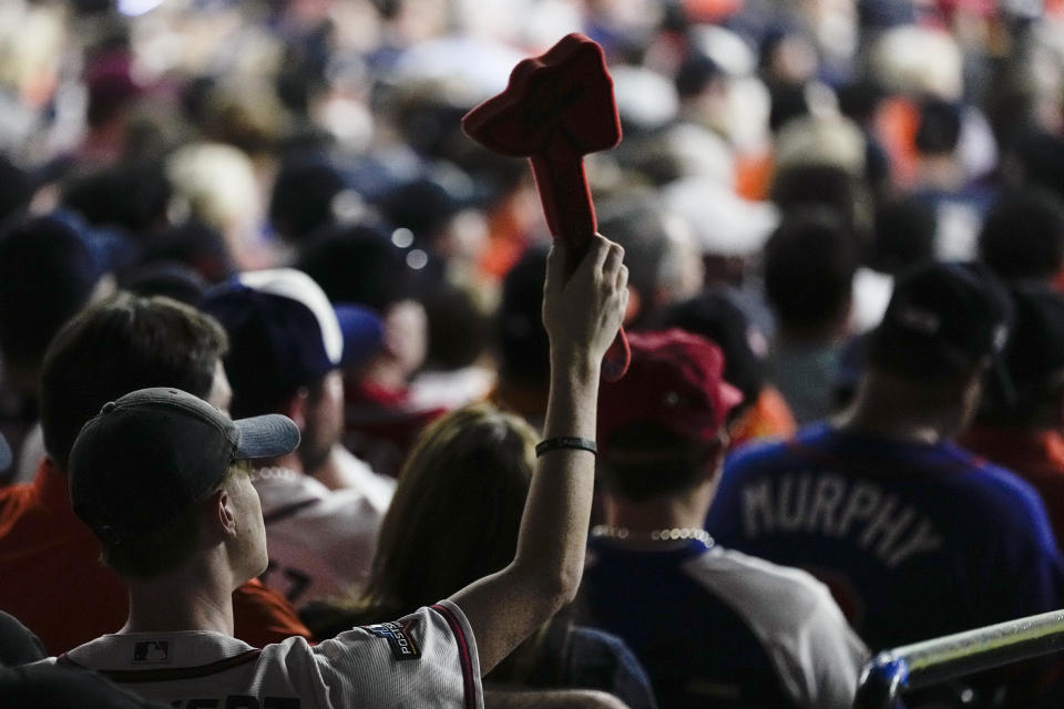 An Atlanta Braves fan does the chop cheer during the sixth inning in Game 2 of baseball's World Series between the Houston Astros and the Braves on Wednesday, Oct. 27, 2021, in Houston. (AP Photo/Ashley Landis)