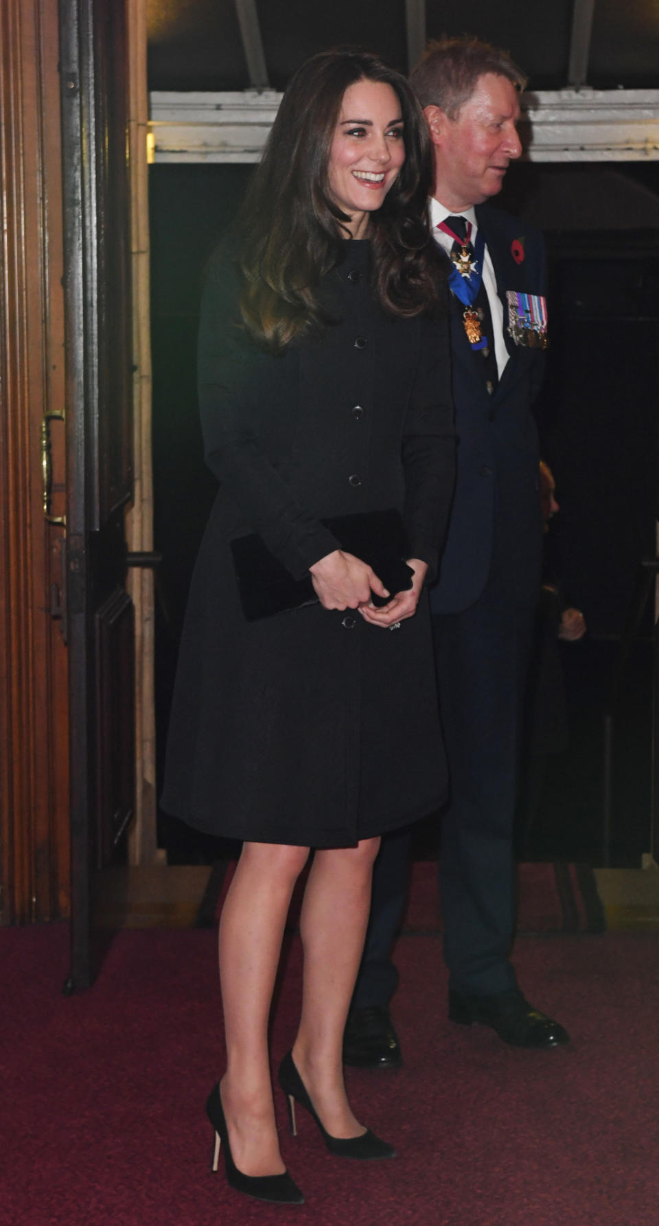 <p>Kate donned a black evening coat by Temperley London for the Festival of Remembrance. Hitting just above the knee, the ensemble was perfect for the Duchess. She paired the design with a velvet bow clutch and black Gianvito Rossi heels. </p><p><i>[Photo: PA]</i></p>