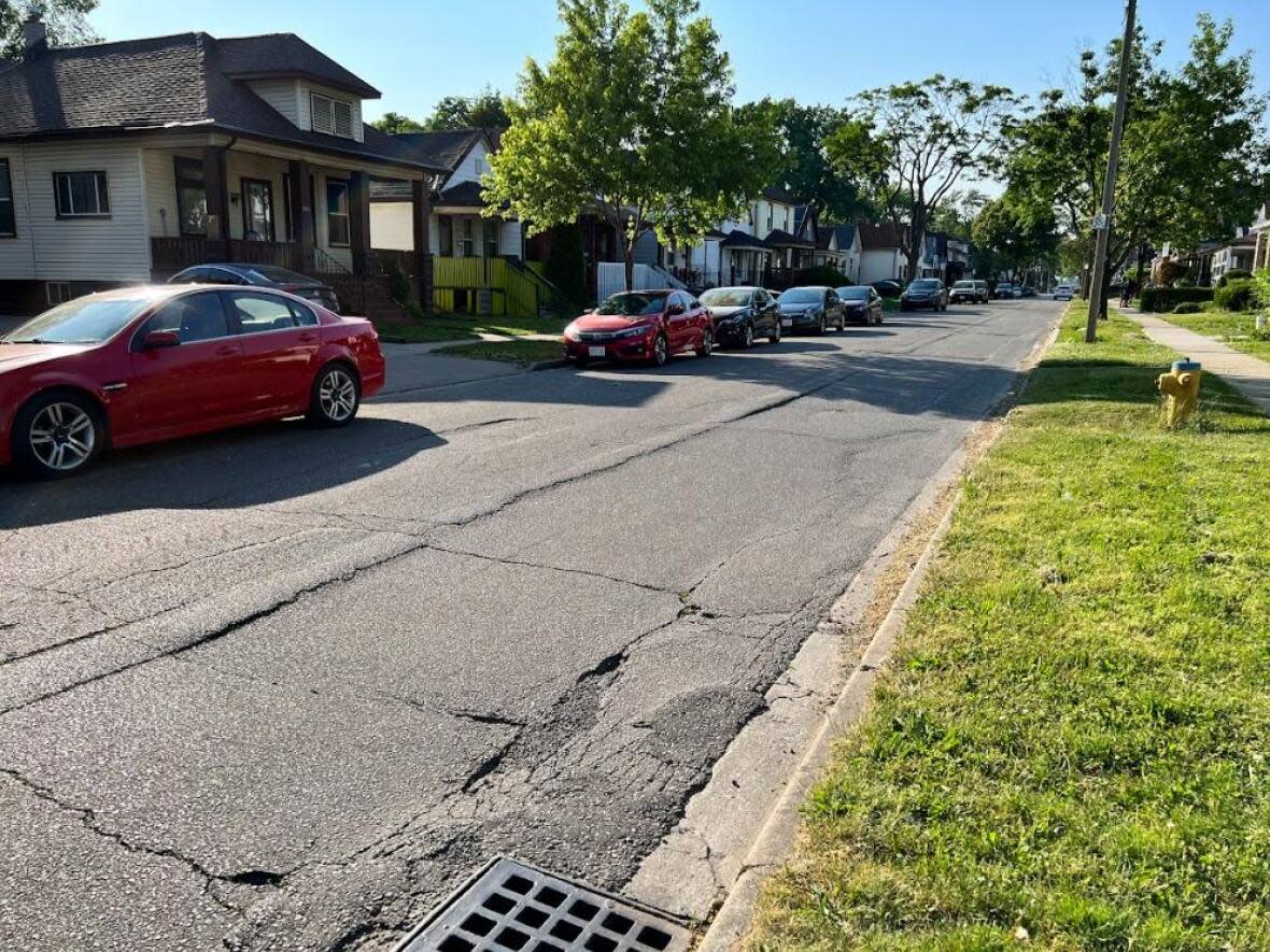 The 400 block of Bridge Avenue in West Windsor. In 2020, a section of the road was patched and refilled by the city, who say the road requires a sewer upgrade and road surface and base repairs. (Josiah Sinanan / CBC - image credit)