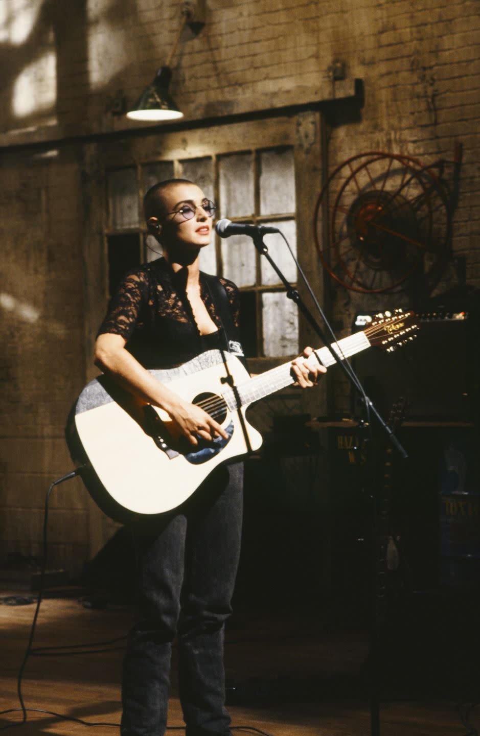 sinead o connor playing a guitar during her performance on saturday night live