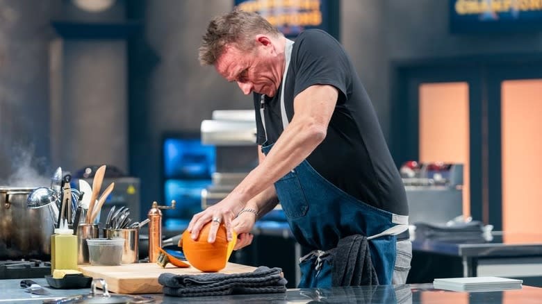 Marc Murphy cutting a pumpkin