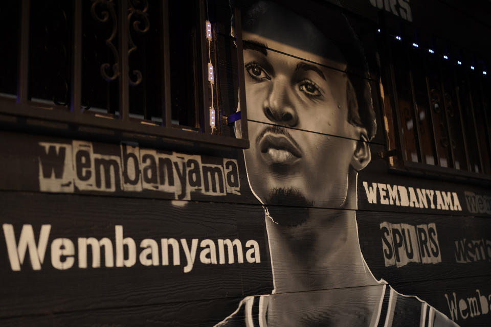 A mural of Victor Wembanyama, a 7-foot-3 French basketball star, painted by artist Nik Soupe is seen on a seafood restaurant in San Antonio, Thursday, June 15, 2023. The San Antonio Spurs are expected to make Wembanyama the No. 1 pick in the NBA draft. (AP Photo/Eric Gay)