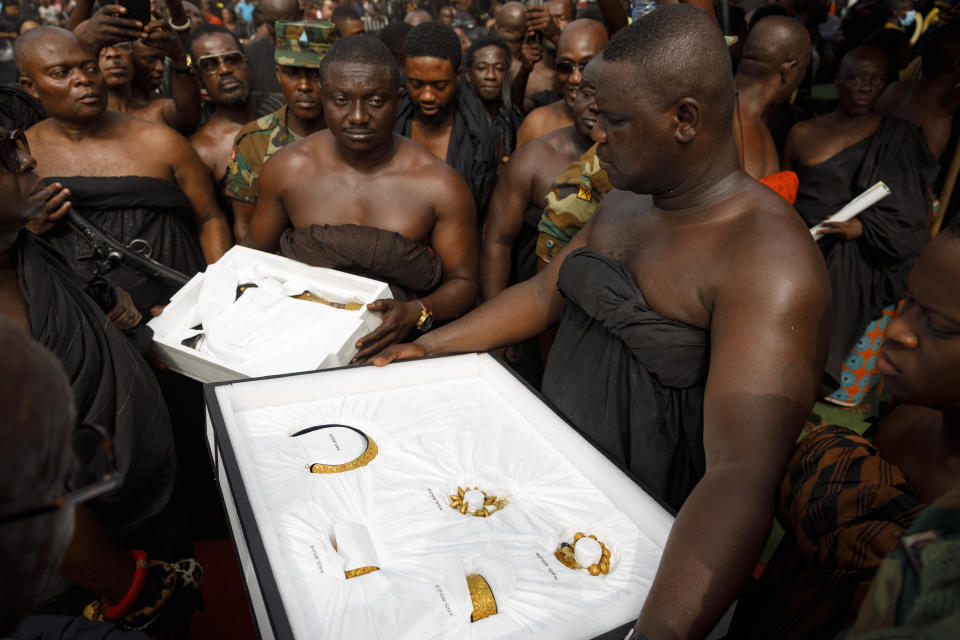 Artefacts returned from UCLA's Fowler museum are carried to Asante King Otumfuo Osei Tutu II at the Manhyia Palace in Kumasi, Ghana, Thursday, Feb. 8, 2024. Seven royal artefacts which were looted by British forces from Ghana's ancient Asante kingdom in the 19th century were returned by the museum, the latest of a series of stolen treasured items now being repatriated to several African countries. (AP Photo/Misper Apawu)