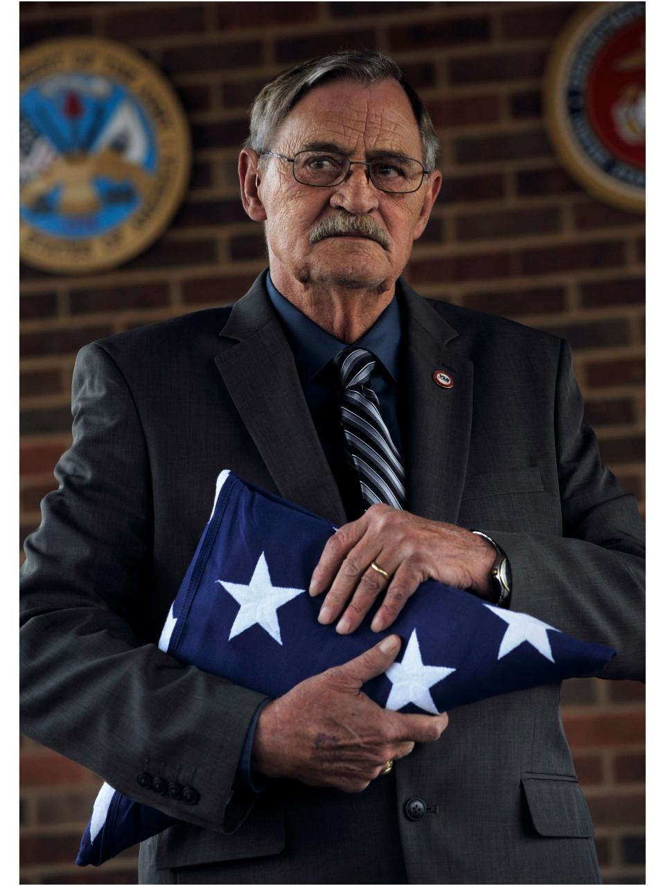 Jimmy DeFoor, the on-site representative at Texas State Veterans Cemetery at Abilene, holds the flag that had draped the casket during Charles Mitchell's unaccompanied veterans funeral Dec. 19, 2017. DeFoor said the cemetery would keep the flag in the event any members of Mitchell's family were located. Mitchell served in the U.S. Air Force from 1976-80.