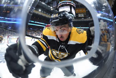 Feb 10, 2019; Boston, MA, USA; Boston Bruins left wing Brad Marchand (63) falls into the boards during the first period against the Colorado Avalanche at TD Garden. Mandatory Credit: Bob DeChiara-USA TODAY Sports