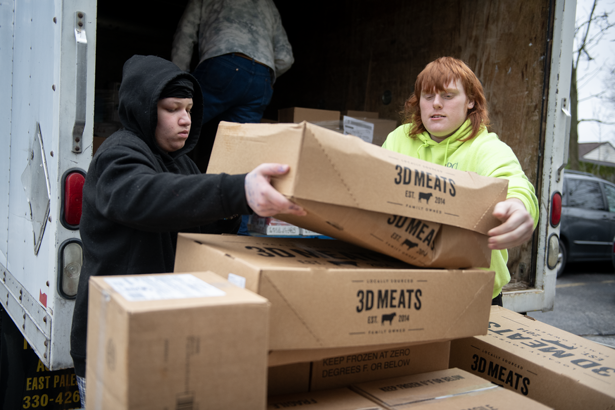 Ravenna High School students Kenyan Mack, 14, and Anthony Columbus, 16, volunteer at Center of Hope.