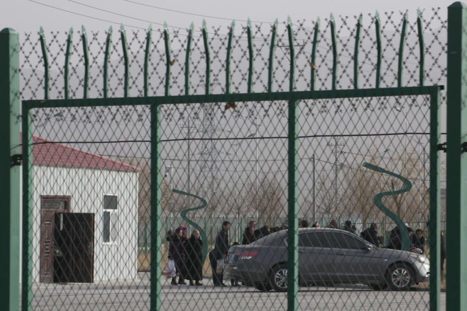 Residents line up at a site reported to be an indoctrination camp in Xinjiang, China.