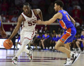 Oklahoma guard Elijah Harkless (55) pushes past Florida guard Myreon Jones (0) during the second half of an NCAA college basketball game in Norman, Okla., Wednesday, Dec. 1, 2021. (AP Photo/Kyle Phillips)